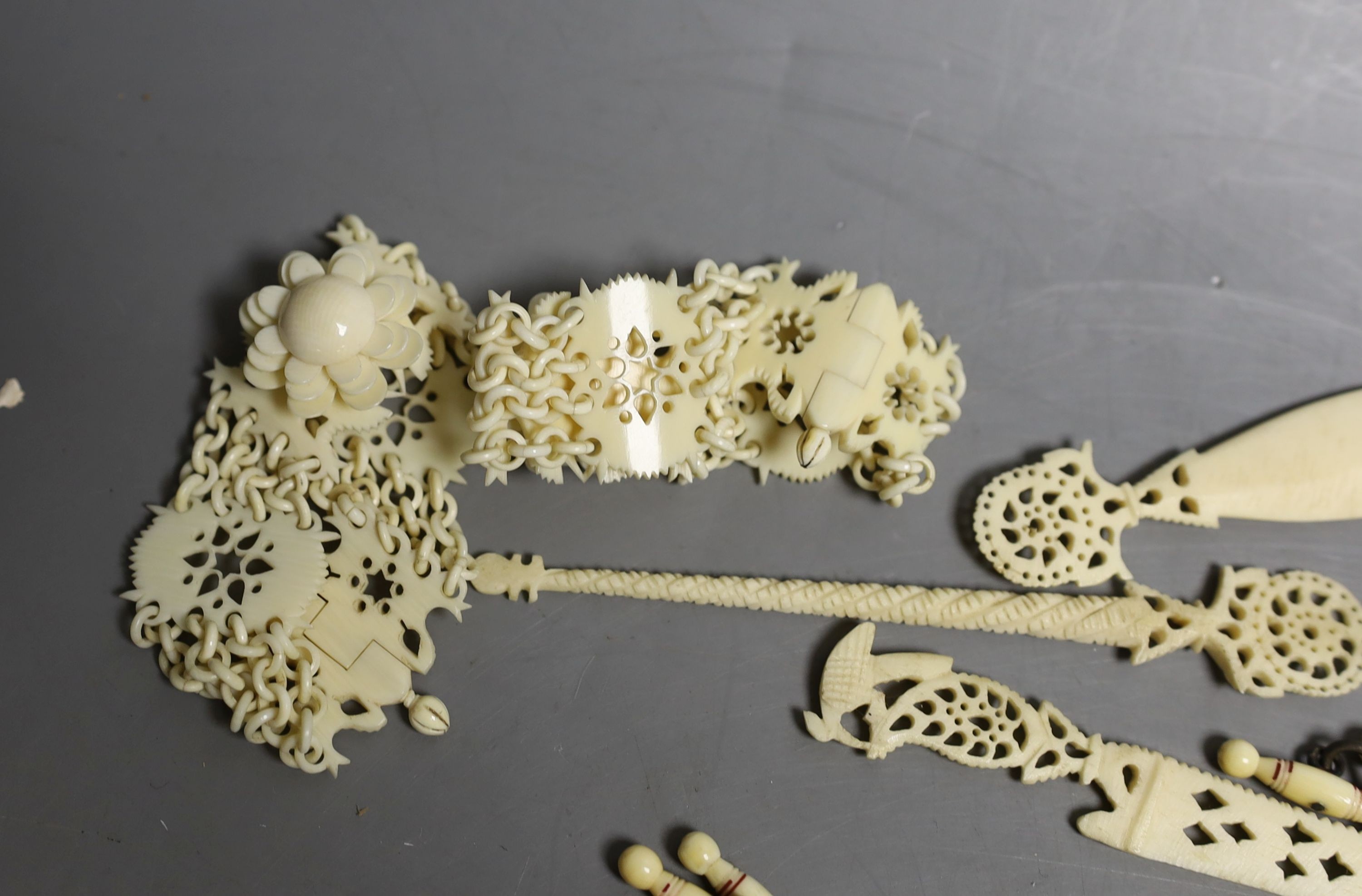 A group of 19th century/early 20th century carved ivory chains, sewing accessories, bracelets etc.